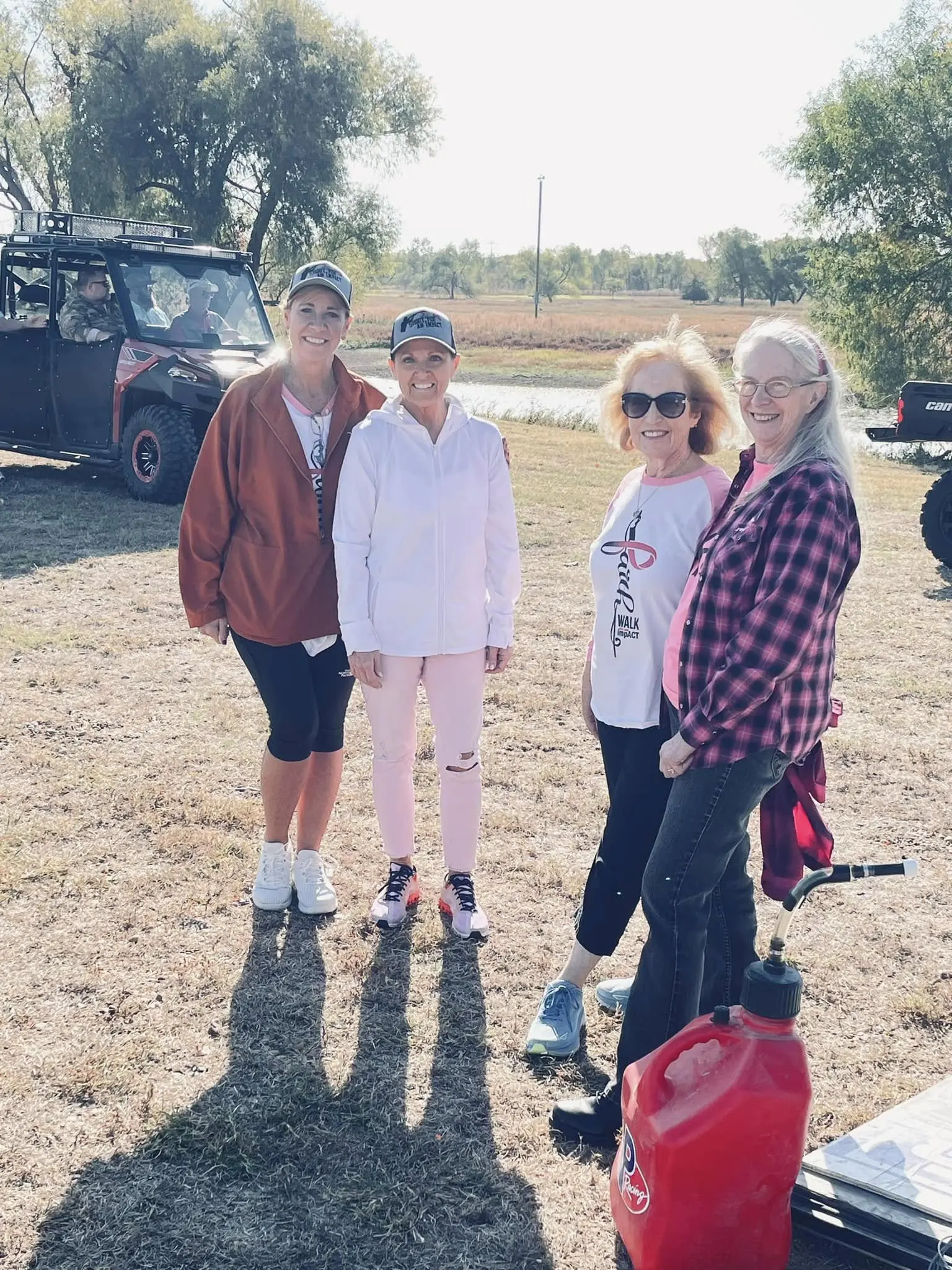 A group of people standing in the dirt.