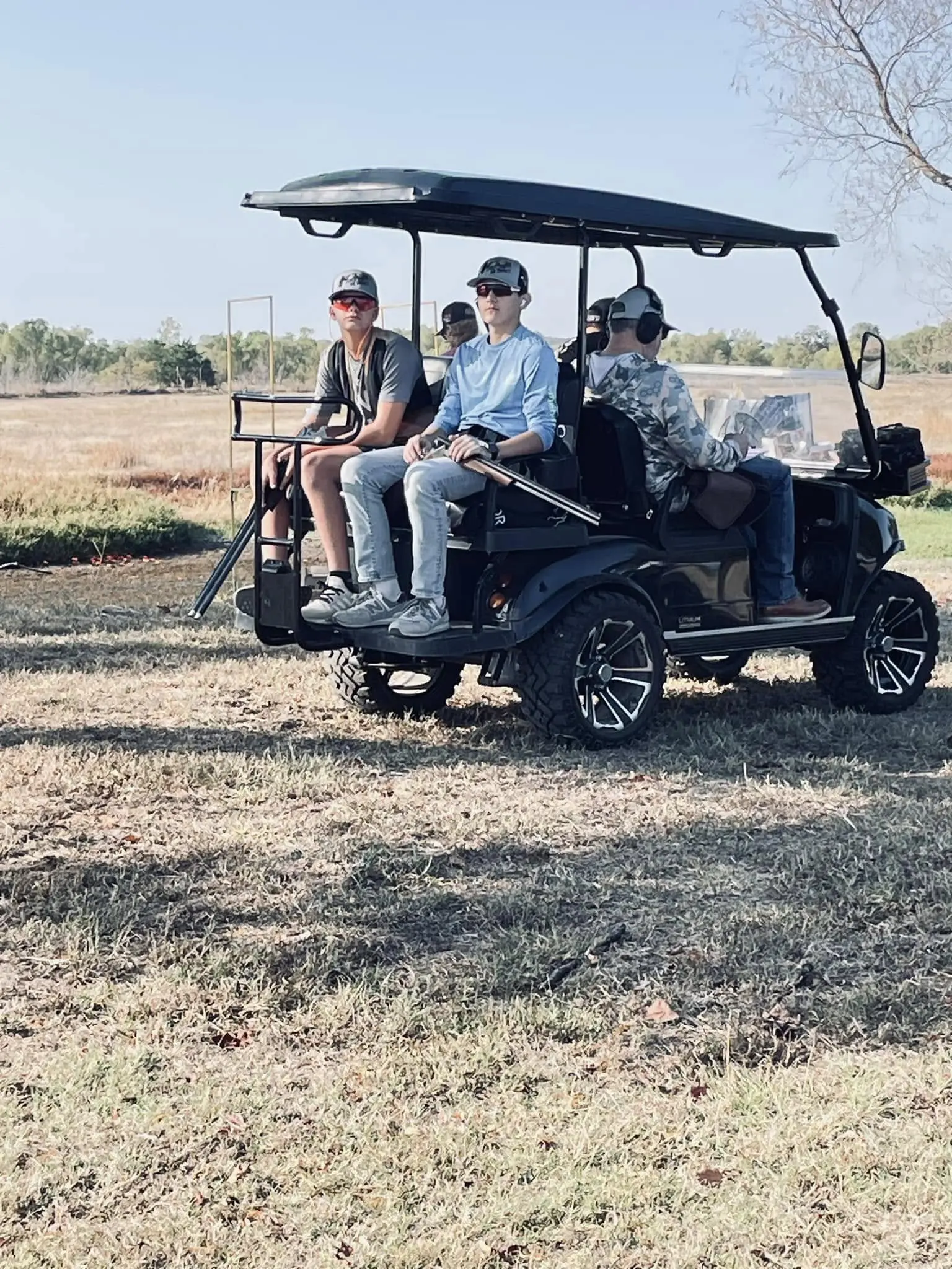 A group of people riding in a golf cart.