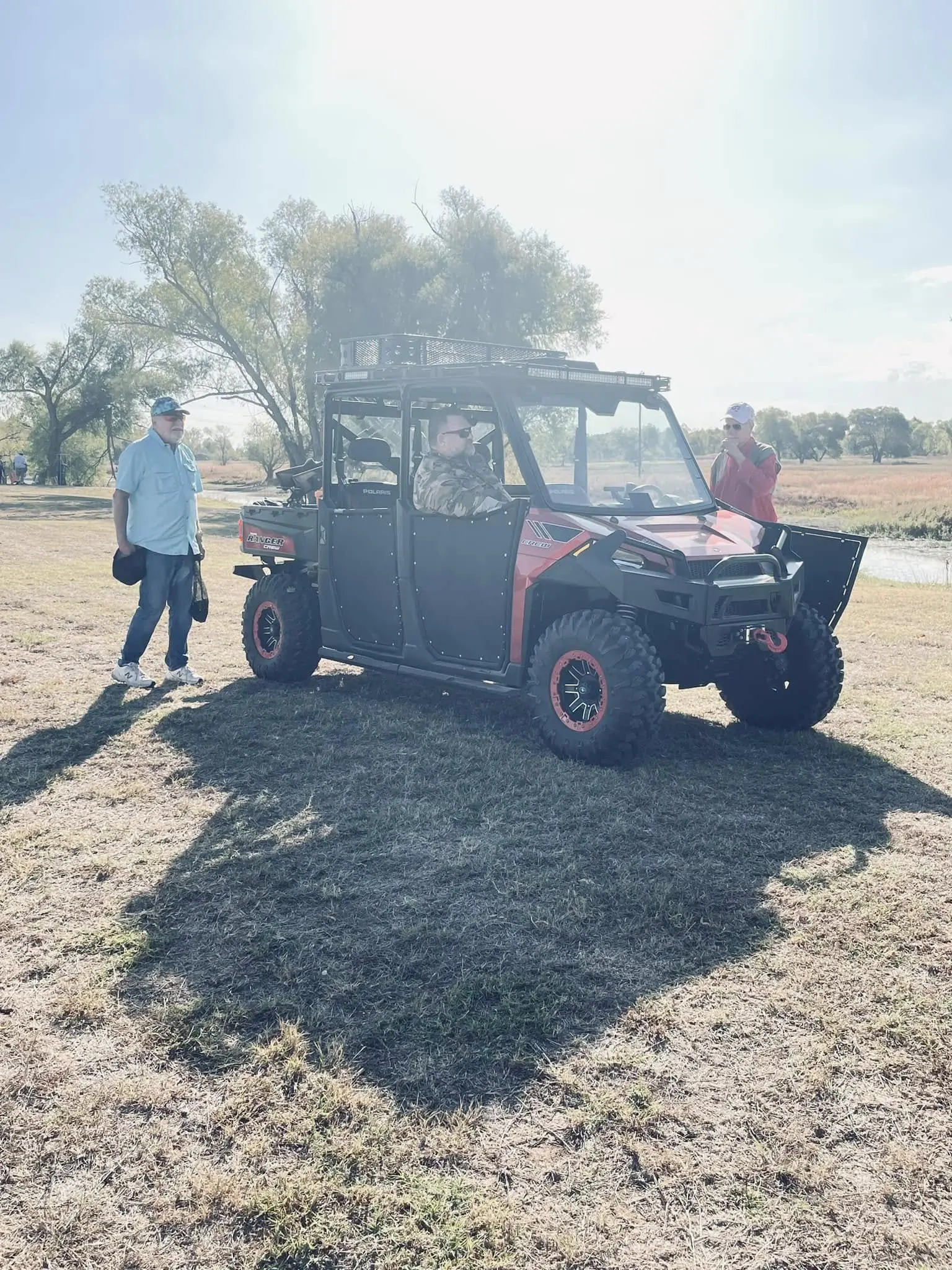 A man and woman standing next to an atv.