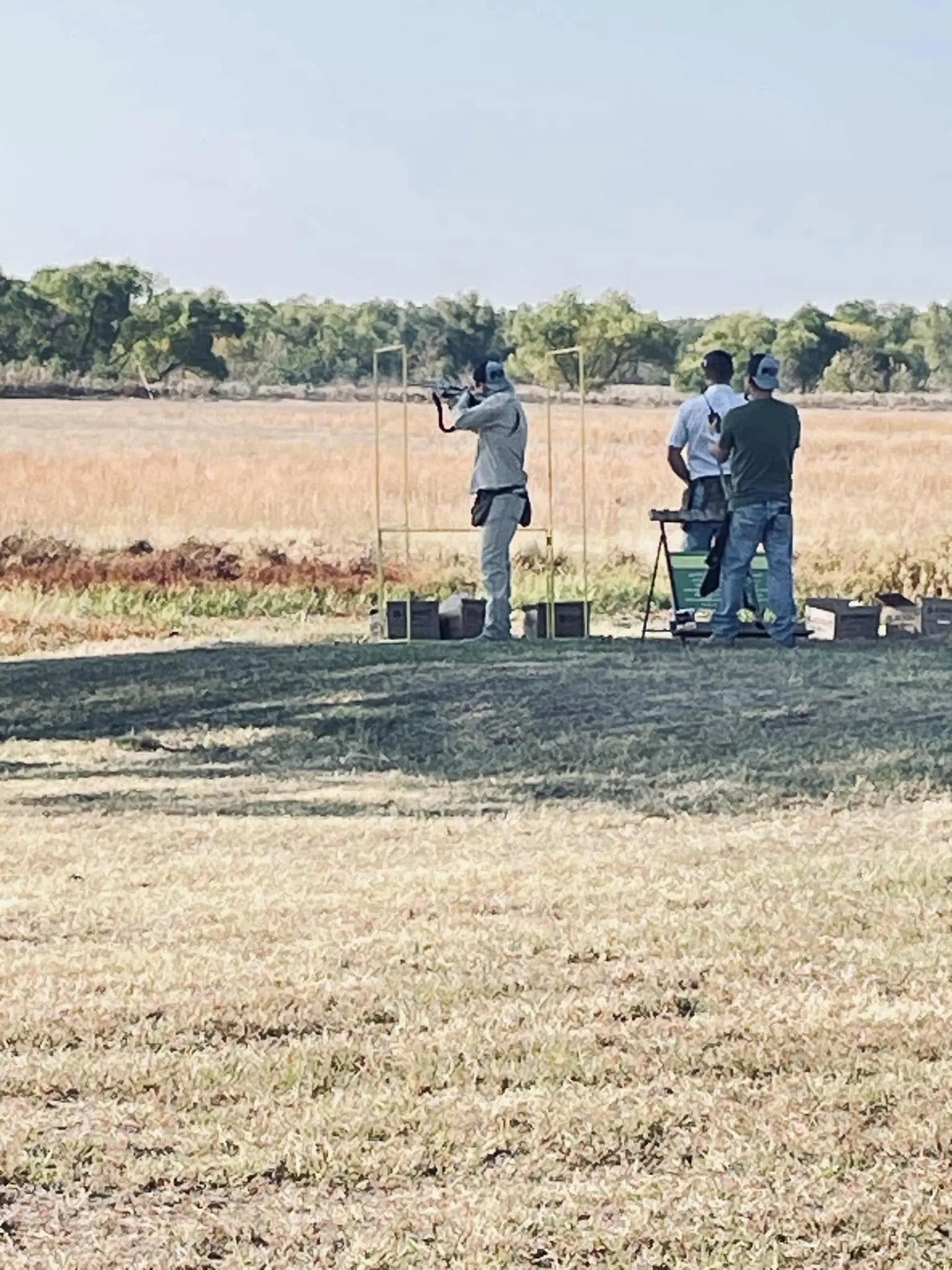 Two people are shooting a gun at an event.